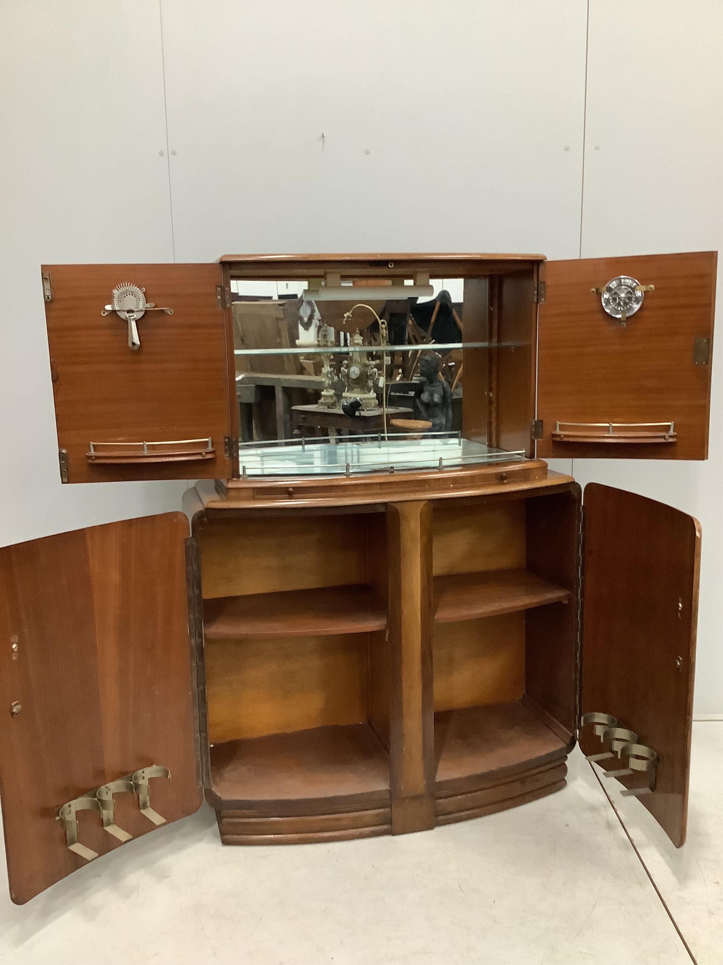 An Art Deco style walnut cocktail cabinet, width 102cm, depth 38cm, height 144cm. Condition - fair